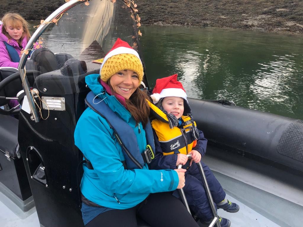 Mother And Child Santa Hats On Boat
