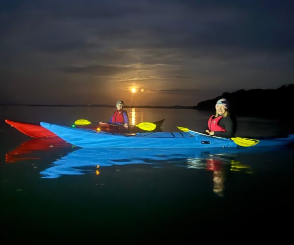 Colorful Kayaks On Moonlit Water