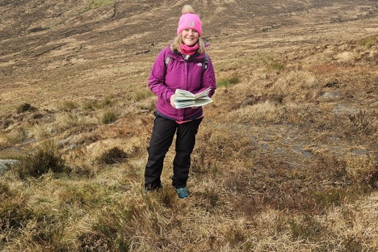 Director Christine Martin Hiking With Map