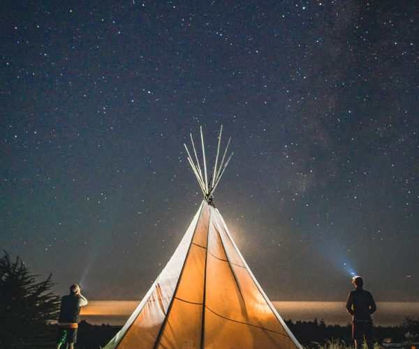 Illuminated Tipi Under Starry Sky