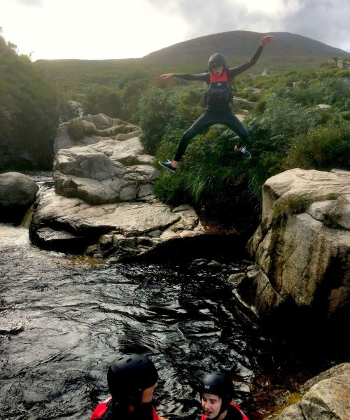 Jumping Off Rocks Into Mountain Pool