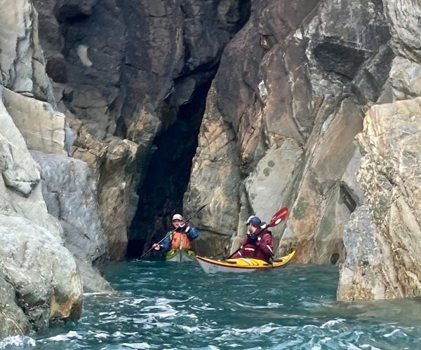 Kayakers Exploring Sea Cave