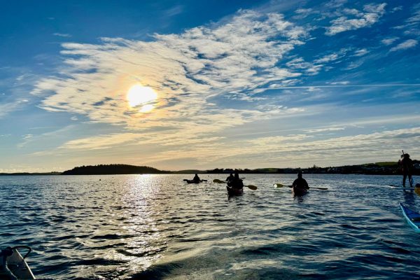 Kayakers Silhouetted Sunset Paddle
