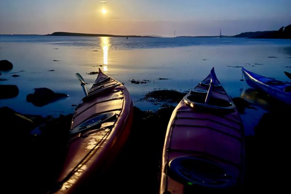 Kayaks Beached Under Moonlight