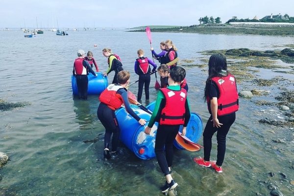 Kids Launching Barrel Raft Into Water