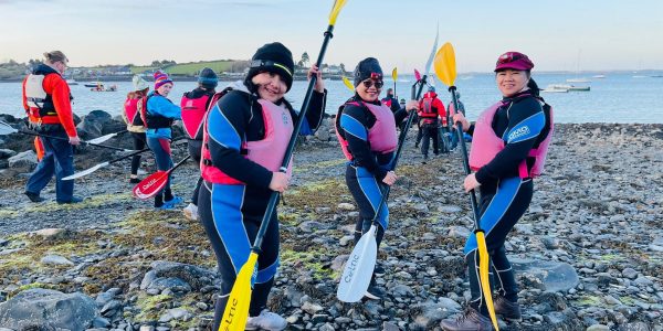 Paddlers With Paddles On Shore
