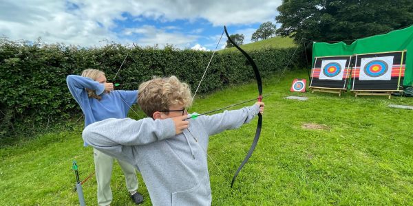 Teenagers Shooting Archery Outdoors