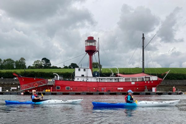 Two Kayakers Near Red Lightship